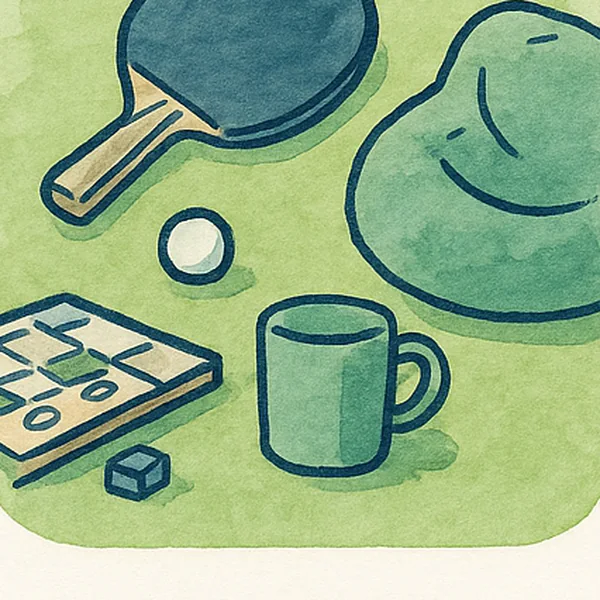 A youth club table with a table tennis bat, a board game and a mug