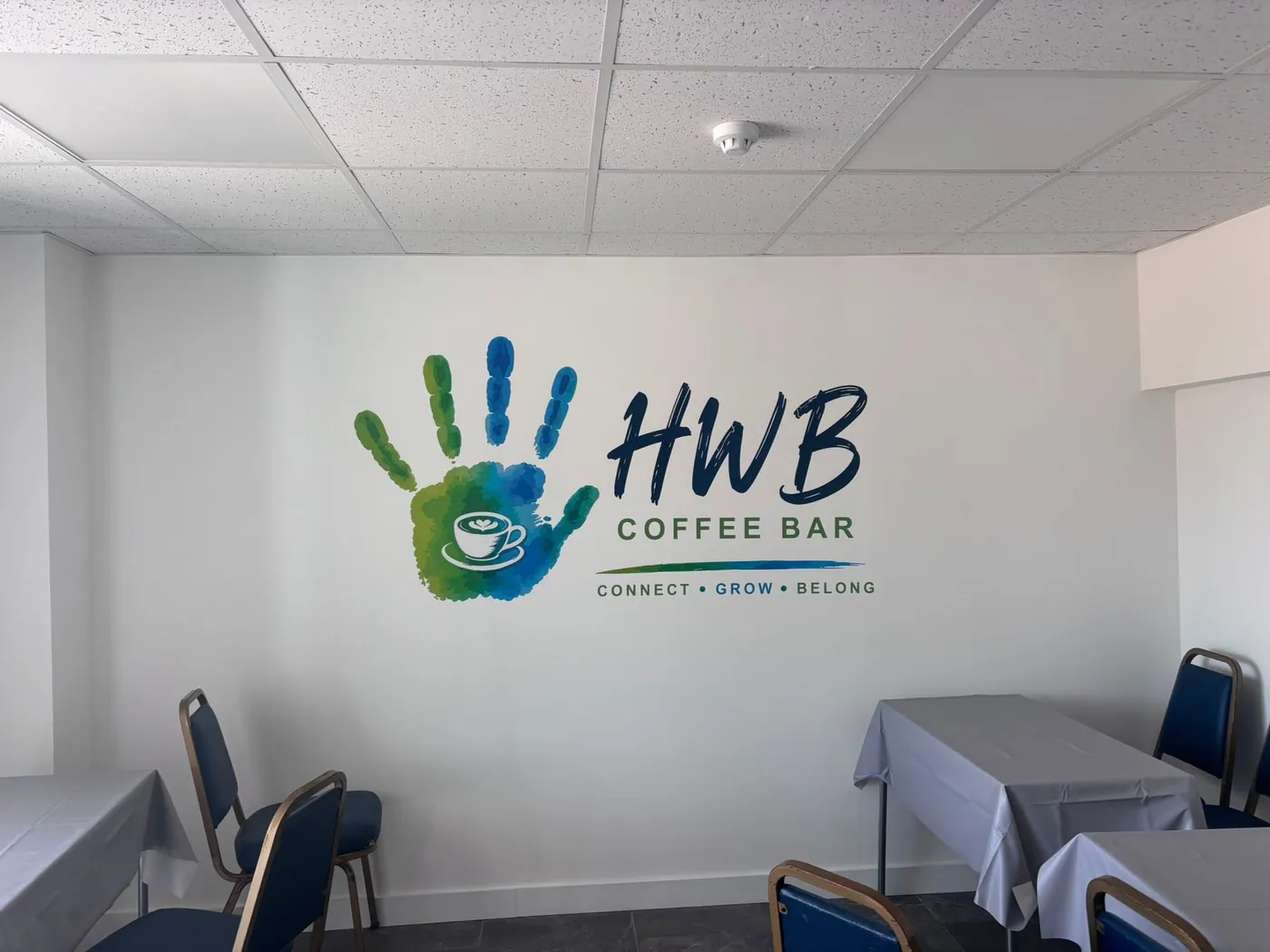 The HWB Coffee Bar with its handprint logo painted on the wall